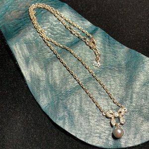 Nina Ricci, sparkly bow with grey faux pearl necklace